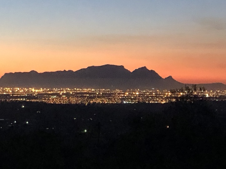 A glorious view of Table Mountain from the garden with the city aglow in the last rays of the sun